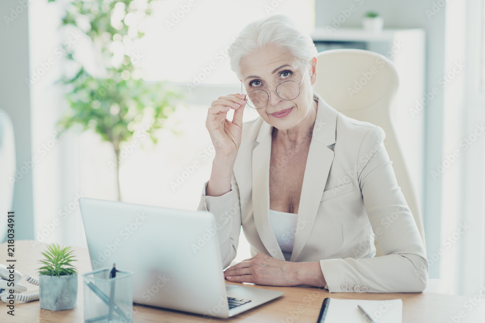 Grey-haired beautiful stylish old serious lady office executive Grey-haired beautiful stylish old serious lady office executive