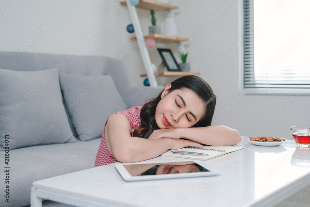 tired asian woman sleeping near couch after work at home tired asian woman sleeping near couch after work at home