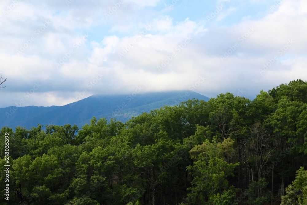 The white fluffy clouds over the mountains in Tennessee.