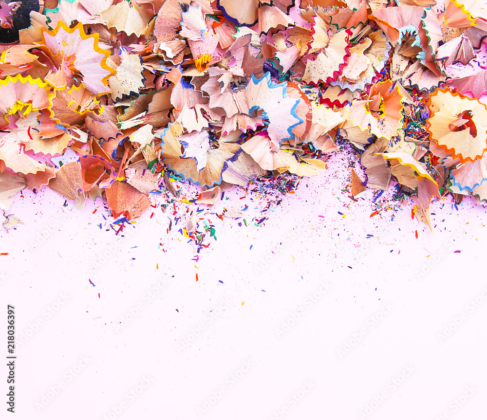 Wooden pencil shavings and colorful crumbs of graphite from sharpener. Top view. Wooden pencil shavings and colorful crumbs of graphite from sharpener. Top view.