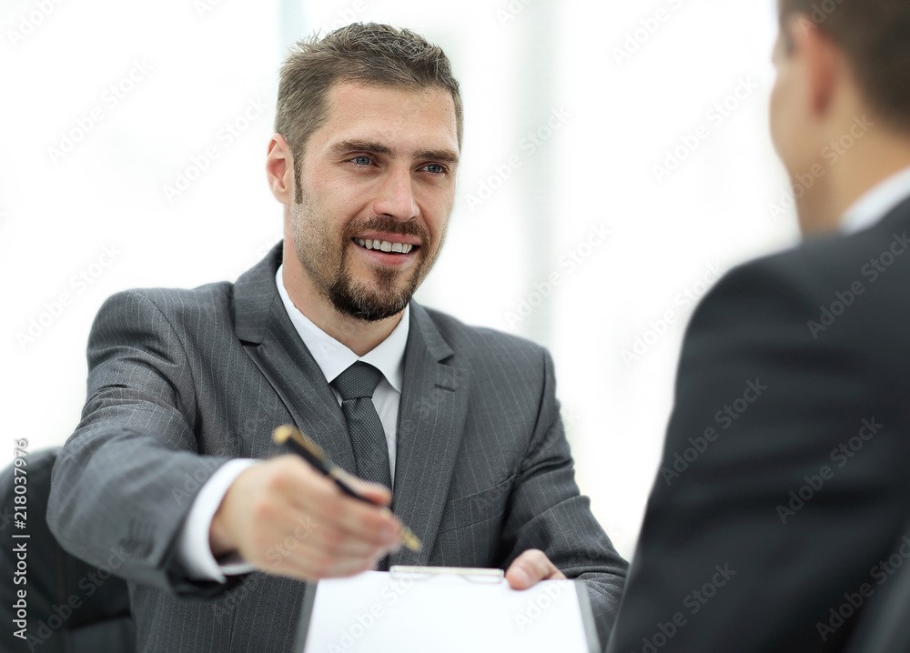 closeup.smiling businessman signing a lucrative contract.the business concept. closeup.smiling businessman signing a lucrative contract.the business concept.