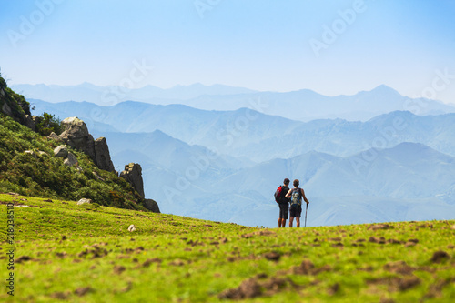 Dos personas haciendo senderismo en las montañas del Sueve, Asturias photo