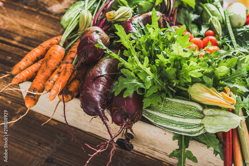 Bio organic vegetables on farmer market, farm fresh vegetable box on wooden background, vegetarian food concept photo