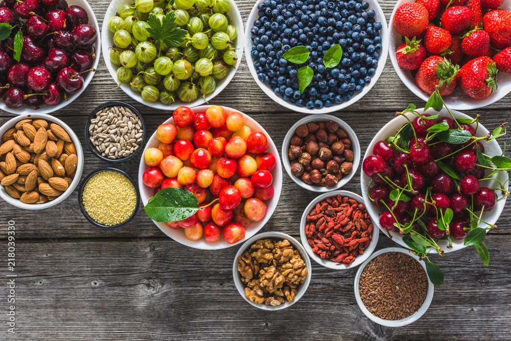 Selection of healthy food, assortment of fruits, berries, nuts and seeds. Vegetarian ingredients on table. Selection of healthy food, assortment of fruits, berries, nuts and seeds. Vegetarian ingredients on table.