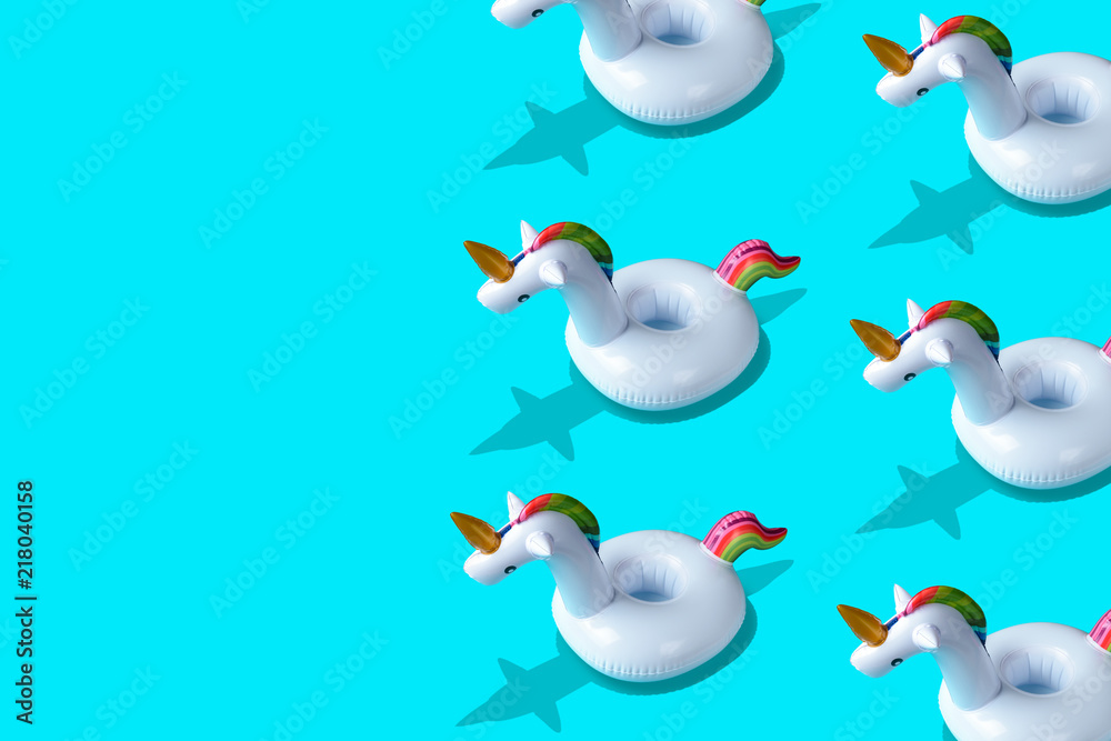 Inflatable unicorn pool toy pattern onl blue background. Minimal summer concept. Inflatable unicorn pool toy pattern onl blue background. Minimal summer concept.