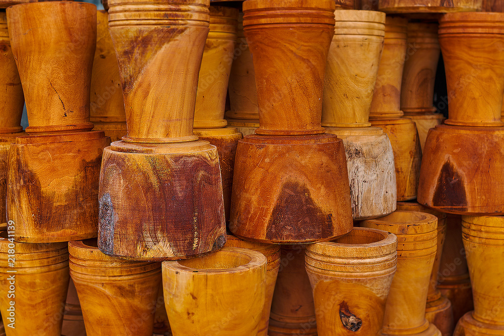 Wooden flower pots from natural wood in the market. Handmade souvenirs. Craft eco product of untreated wood for sale. Wooden crafts on a stall in the market. Walnut handmade wood flower pots. Wooden flower pots from natural wood in the market. Handmade souvenirs. Craft eco product of untreated wood for sale. Wooden crafts on a stall in the market. Walnut handmade wood flower pots.
