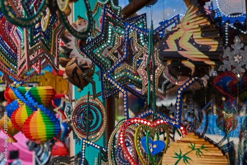 Various objects displayed in an souvenirs shop. Colorful souvenir background. Collection of colorful wooden different things in the market. Stars  hearts and fans decorated. Selective focus.