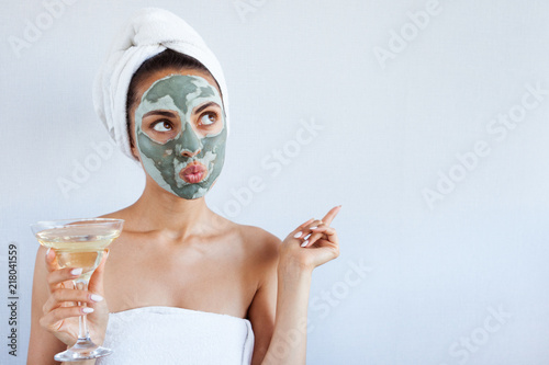 Young beautiful woman in face mask of therapeutic blue mud. Spa treatment, self care and healthy skin
