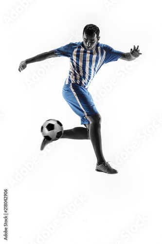 Professional football soccer player with ball isolated on white studio background