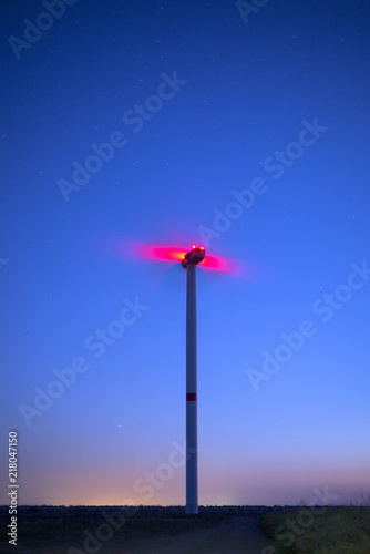 view to red lights on the wind generator in blue evening