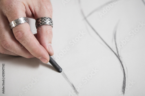 Close-up of artist drawing a sketch photo