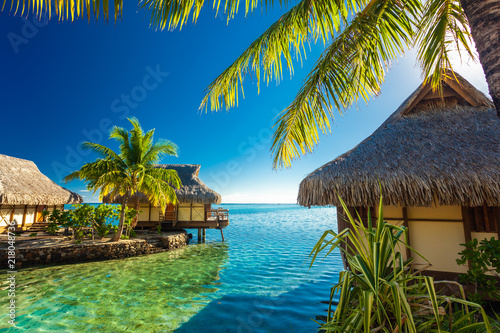 Fototapeta Over water bungalows and green lagoon, Moorea, French Polynesia