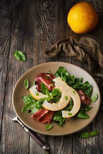 Concept of italian food with melon and prosciutto photo