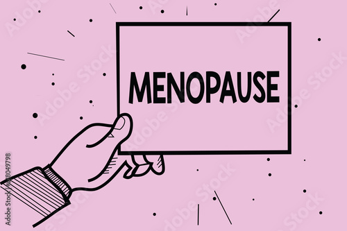 Word writing text Menopause. Business concept for Period of permanent cessation or end of menstruation cycle Man hand holding paper communicating information dotted purple background photo