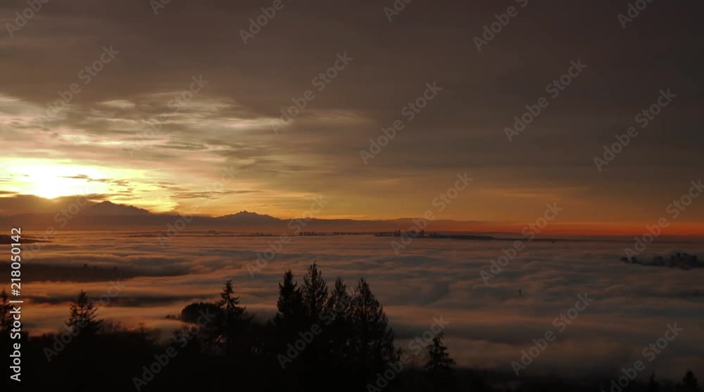 Time lapse of Intense fog covering city and Lions Gate Bridge in Vancouver, BC with Mt. Baker in the background Time lapse of Intense fog covering city and Lions Gate Bridge in Vancouver, BC with Mt. Baker in the background