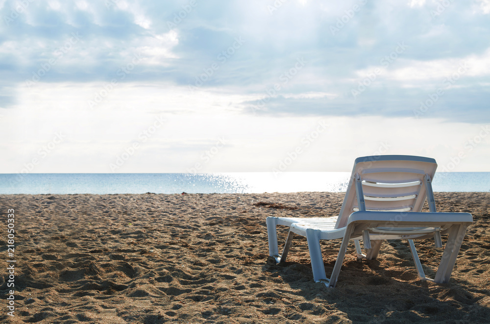 Back view empty chaise lounge before ocean Back view empty chaise lounge before ocean