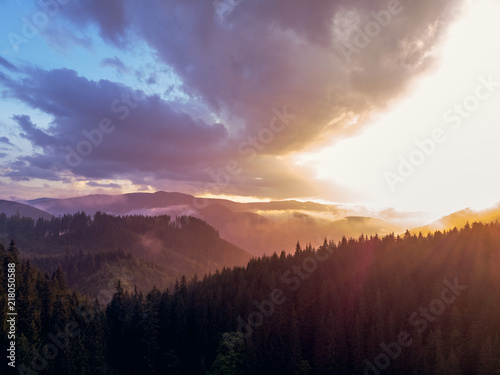 beautiful aerial view of the mountains and the blue lake  the sunset after the rain  the coniferous forest  the purple clouds  Best place in  tourism and nature concept  the Carpathians Ukraine