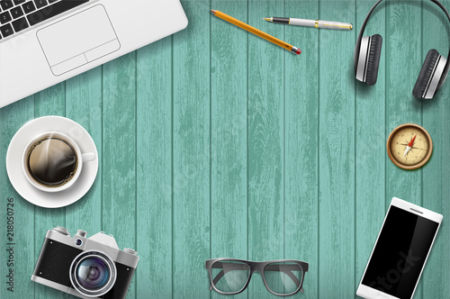 Blank green a wooden table with technology devices. Travel background.