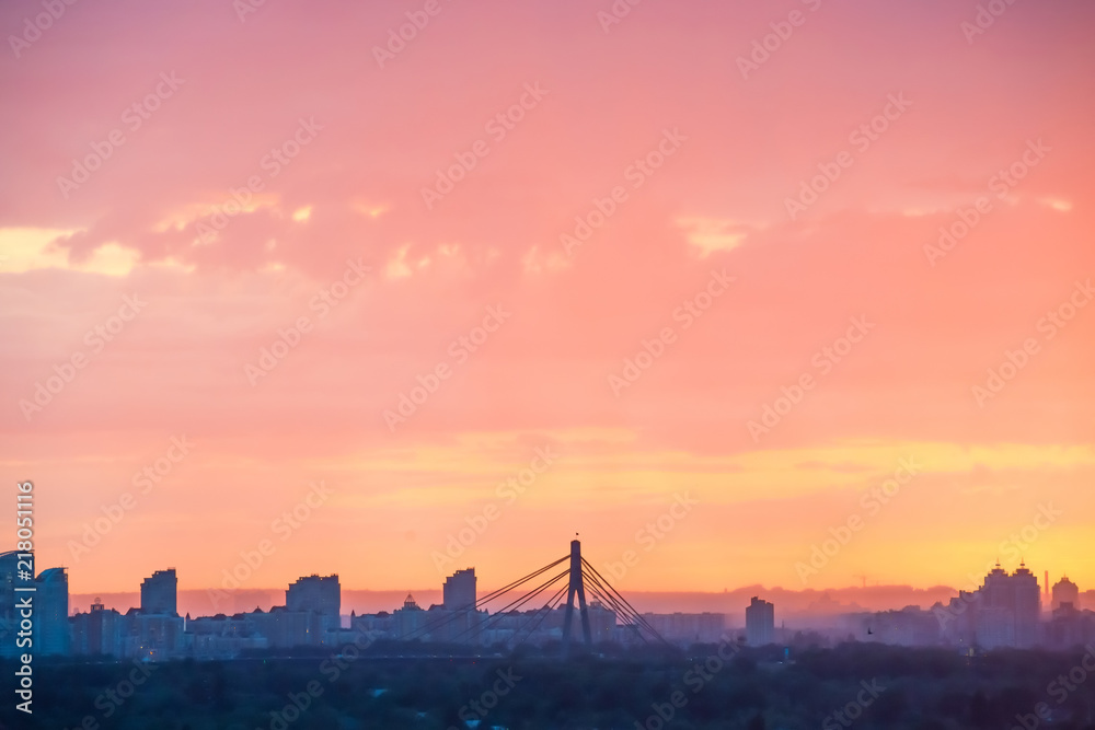 Modern cityscape with bridge and skyscrapers against beautiful colourful sunset Modern cityscape with bridge and skyscrapers against beautiful colourful sunset