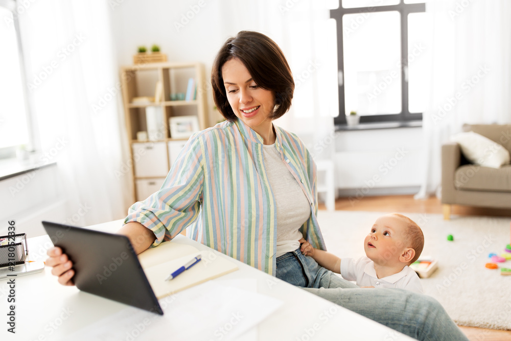 multi-tasking, freelance and motherhood concept - working mother with tablet pc computer and baby boy at home multi-tasking, freelance and motherhood concept - working mother with tablet pc computer and baby boy at home