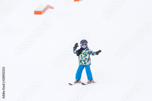 Cute preschool child, boy, skiing happily in aAustrian ski resort, wintertime