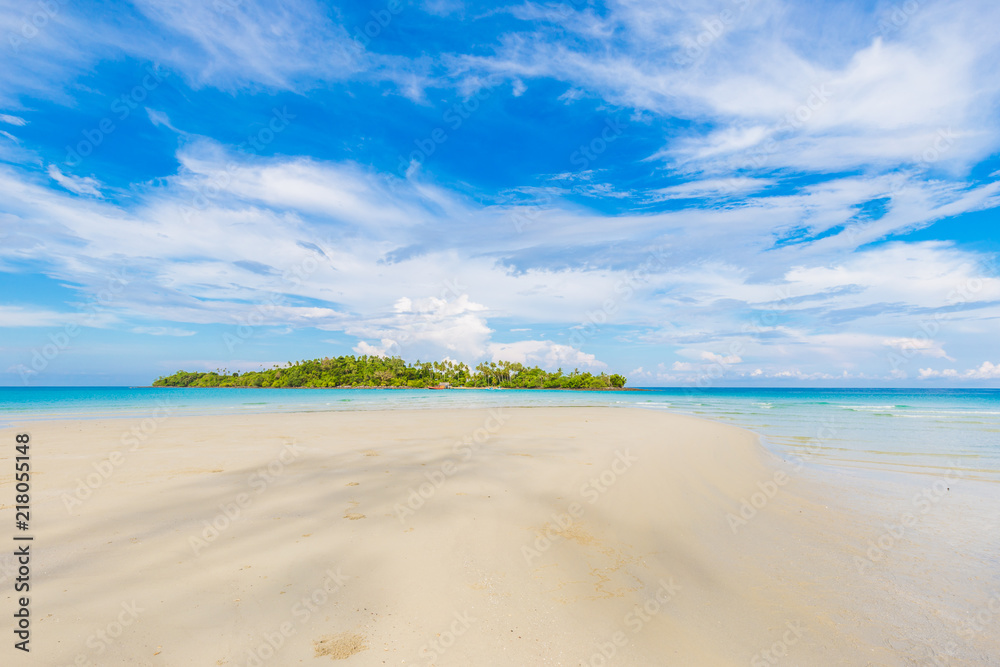 Tropical empty tranquil white sand beach with green forest island