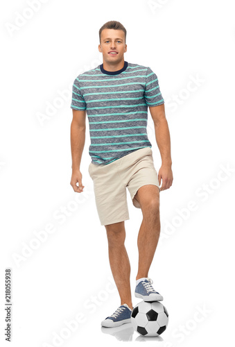 sport, leisure and people concept - smiling young man with soccer ball over white background