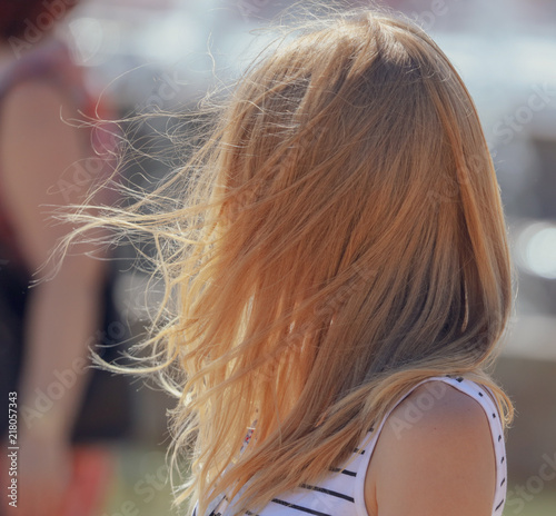 Long hair on a girl's head in the wind