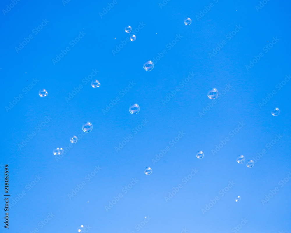 Soap bubbles in flight against the blue sky Soap bubbles in flight against the blue sky