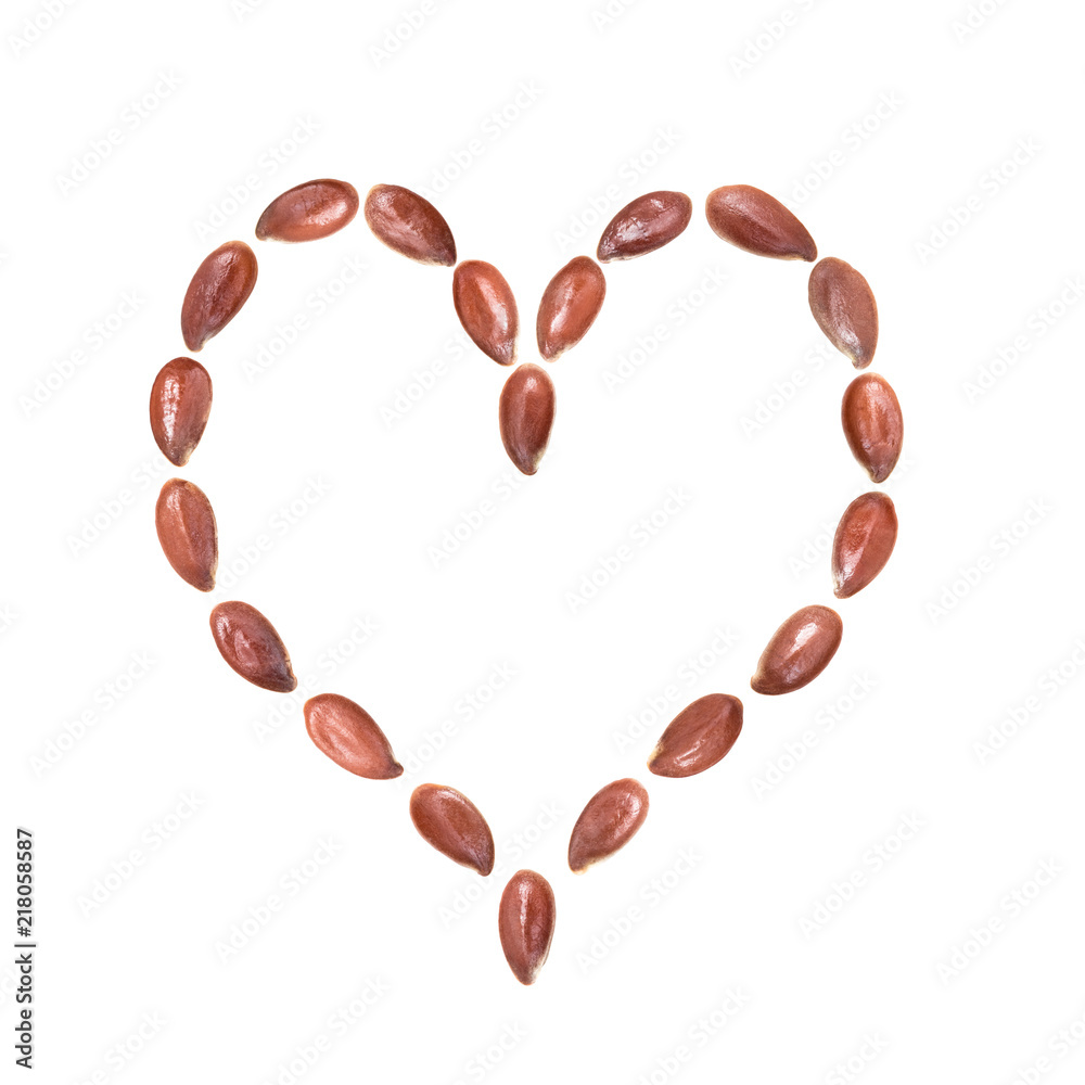 Close up of linseeds or flax seeds arranged in a heart shape isolated on white background Close up of linseeds or flax seeds arranged in a heart shape isolated on white background