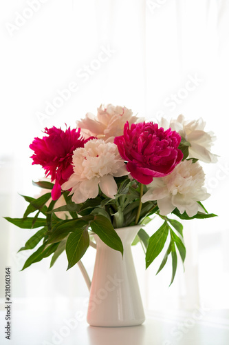 Wallpaper Mural White and pink peonies in vase on white table Torontodigital.ca
