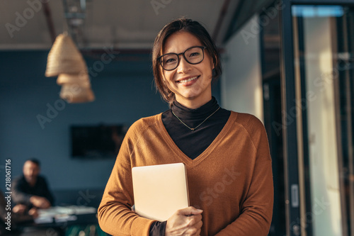 Smiling woman in casuals in office