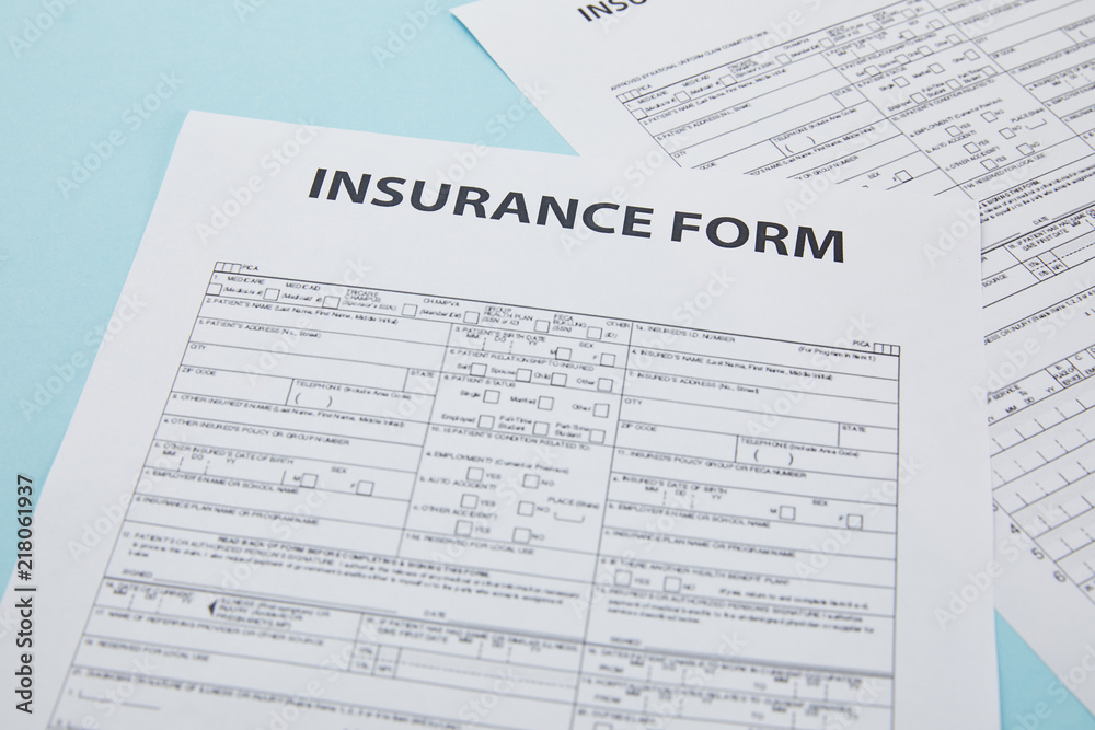 close-up view of insurance form on blue, insurance concept close-up view of insurance form on blue, insurance concept