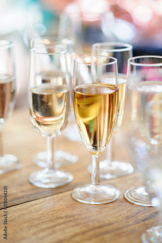 Champagne glasses on wooden table. Selective focus and shallow depth of field. Champagne glasses on wooden table. Selective focus and shallow depth of field.