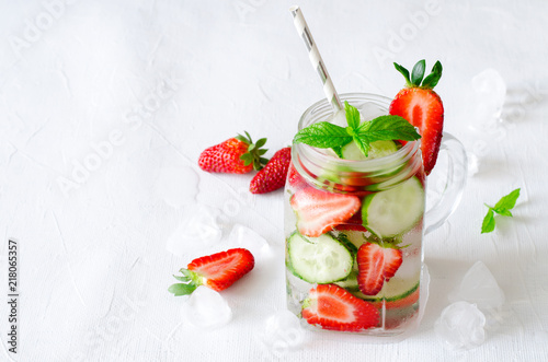 Summer refreshing iced drinks with cucumber and strawberry on white background