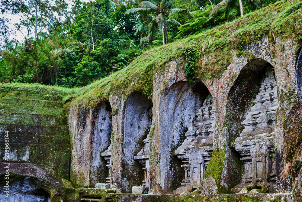 Gunung Kawi Temple and Candi (shrines) in jungle at Bali, Indonesia. Old temples in the jungle. Ancient temple ruins. Carved in stone temple. Elements ancient stone.