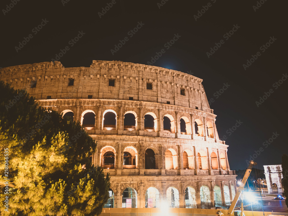 Roman colosseo by night. Ancient colosseum on black sky background.