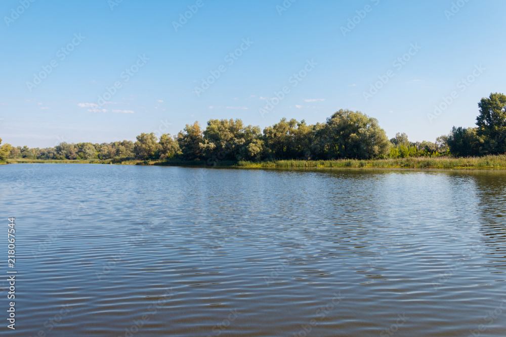 Summer landscape with beautiful river, green trees and blue sky Summer landscape with beautiful river, green trees and blue sky