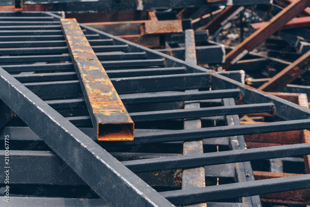 pile of the black rusty metal at the construction site. pile of the black rusty metal at the construction site.