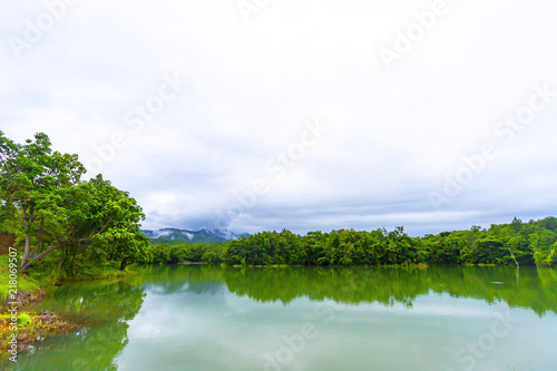A small lake near the mountains in the rainy morning.