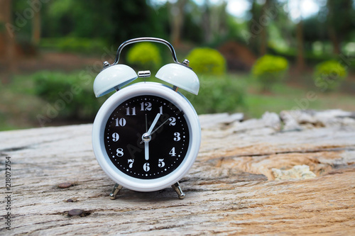 Retro alarm clock on old wooden table photo