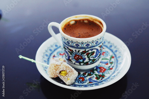 strong coffee and sweets in a cup with a well-defined pattern on a black and gray background