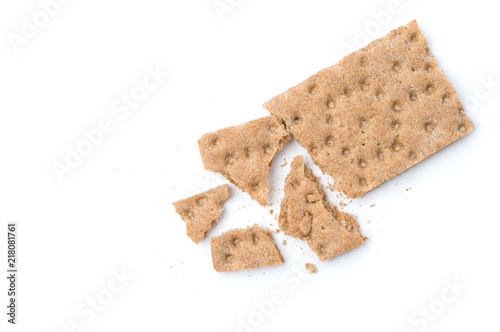 Crunchy crispbread with crumbs on white background.