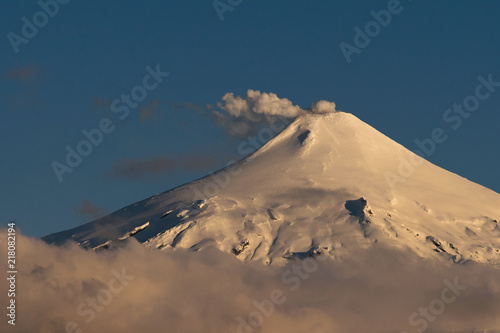 Fumarolas leave the Villarrica volcano, while falling begins to fall from the city of Pucón, Chile.