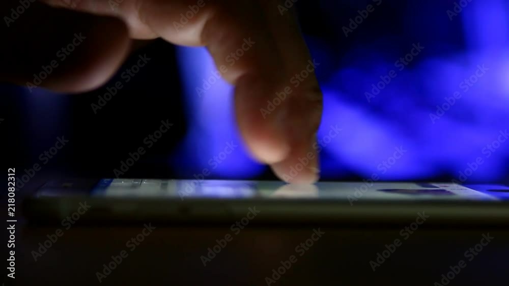 Man touching smartphone by finger Man touching smartphone by finger
