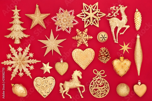Luxury gold Christmas bauble decorations on red background. Traditional festive card for the Christmas holiday season.