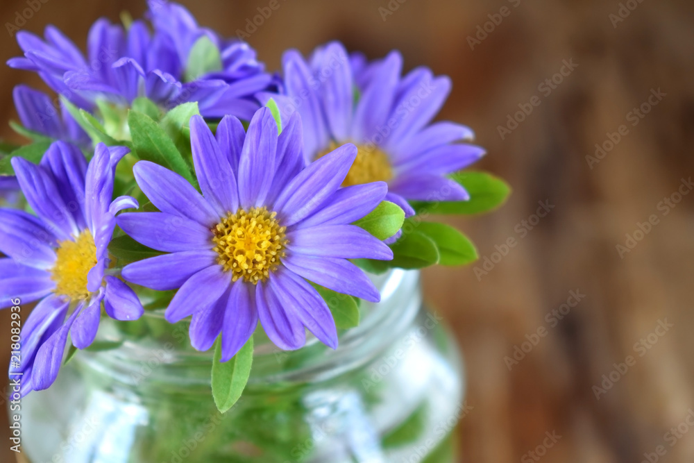 Bouquet of little violet asters against the wooden background Bouquet of little violet asters against the wooden background