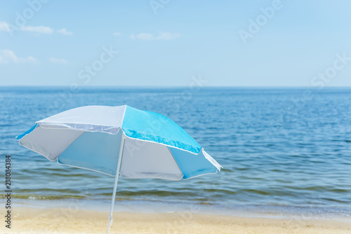 umbrella on sand beach and sea background. soft focus © Mykola Mazuryk