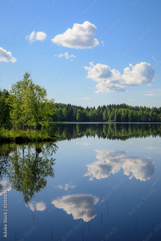 Fototapeta premium Sky reflects from still lake at summer day