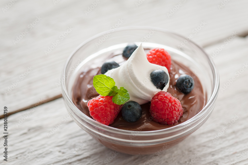 Berries on chocolate pudding with a dollop of cream Berries on chocolate pudding with a dollop of cream